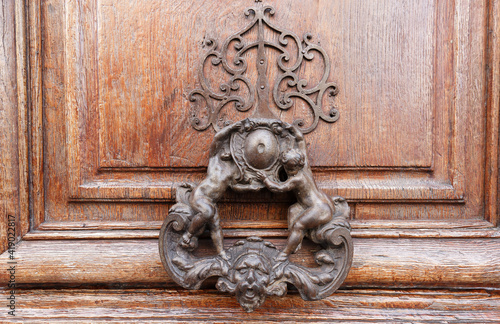 European Vintage old metal wrought iron door knocker. Design detail. Paris.