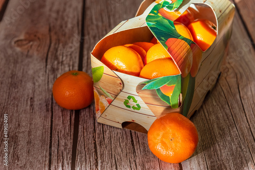 Fresh mandarin oranges fruit or tangerines on wooden background