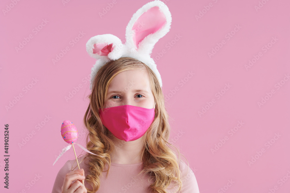 stylish child with long wavy blond hair on pink stylish child with long wavy blond hair on pink