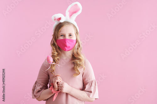 modern child with long wavy blond hair on pink