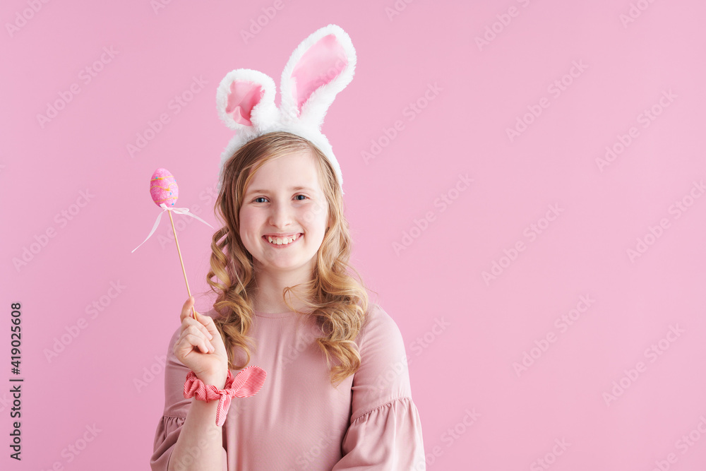 Portrait of happy stylish girl in pink dress on pink