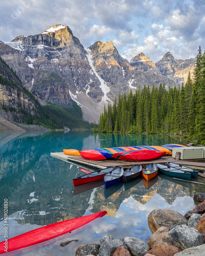 Canoes on Moraine Lake during a Summer Sunrise at Lake Louise in Banff National Park in the Rocky Mountains, Alberta, Canada