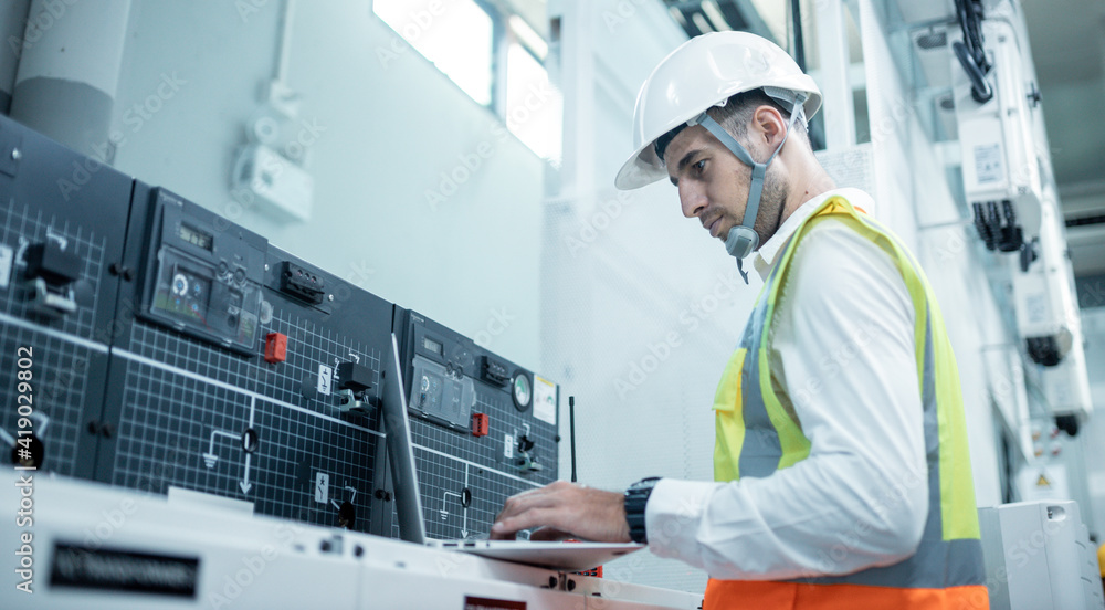 Electrician engineer tests electrical installations and wires on relay protection system. Bay control unit. Medium voltage switchgear Electrician engineer tests electrical installations and wires on relay protection system. Bay control unit. Medium voltage switchgear