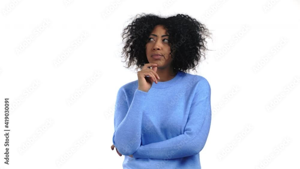 Thinking mixed race woman looking up and around on white studio background. Pensive face expressions. Pretty afro model with attractive appearance Thinking mixed race woman looking up and around on white studio background. Pensive face expressions. Pretty afro model with attractive appearance