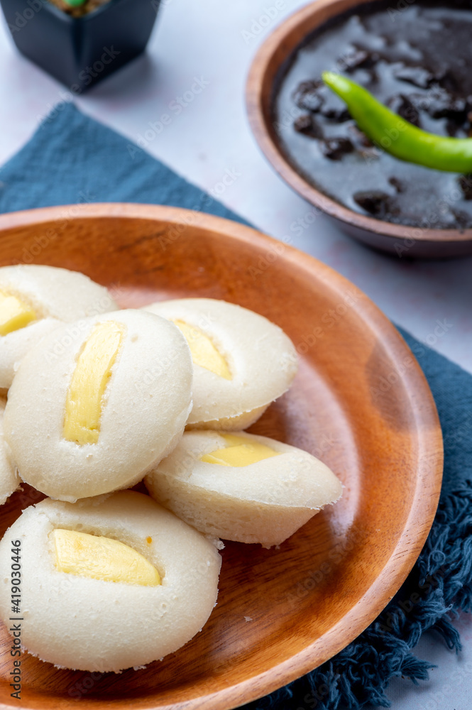 Cheese Puto (vertical) paired with Dinuguan (Pork Blood Stew) a famous Filipino delicacy best