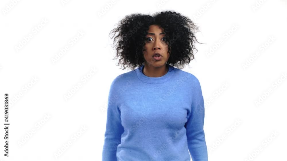 African american furious woman shouting on white background. Lady in stress and rage, she threatens with aggression and looking at camera. African american furious woman shouting on white background. Lady in stress and rage, she threatens with aggression and looking at camera.