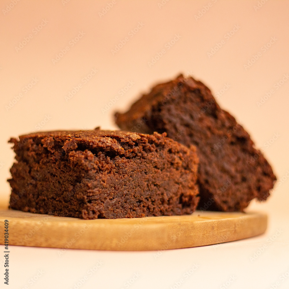 Side view of delicious gluten-free, sugar-free chocolate brownies on a wooden board. vegan desserts. Marijuana brownies, magical. Side view of delicious gluten-free, sugar-free chocolate brownies on a wooden board. vegan desserts. Marijuana brownies, magical.