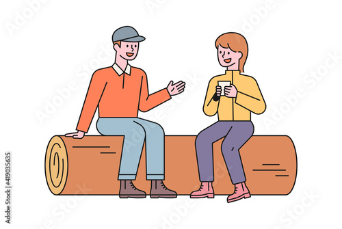  A man and a woman are sitting on a log and talking while resting. flat design style minimal vector illustration.