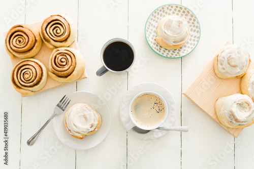 Beautiful wooden table with cinnamon rolls and coffee cups