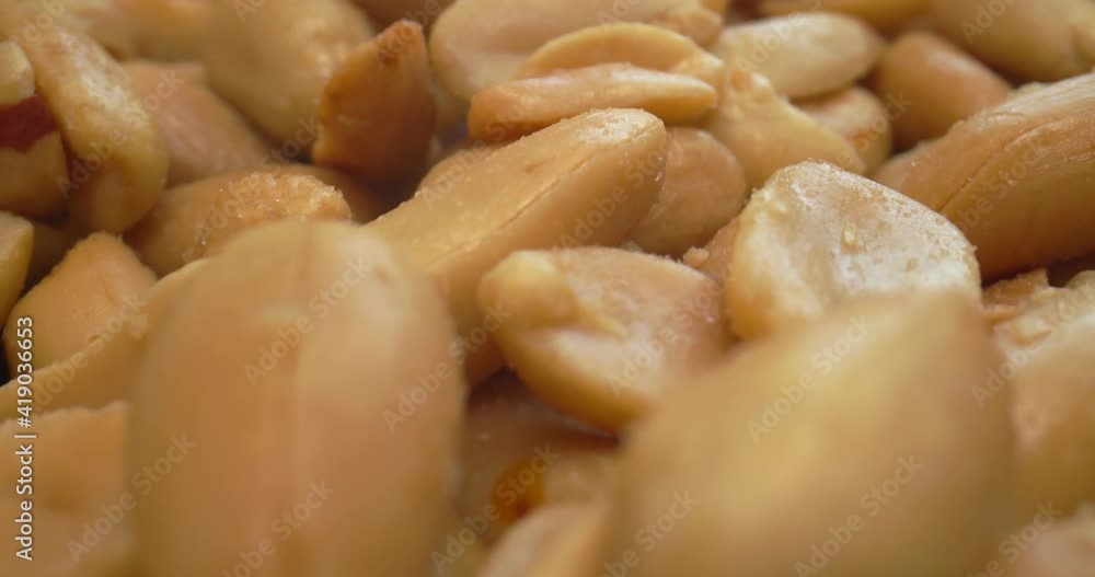 Macro probe shot of roasted and salted peanuts. Shot in 4K on a cinema camera. Macro probe shot of roasted and salted peanuts. Shot in 4K on a cinema camera.