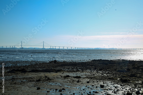 A tidal flat with a view of Incheon Bridge in the blue sky 파란하늘에 인천대교가 보이는 갯벌 photo