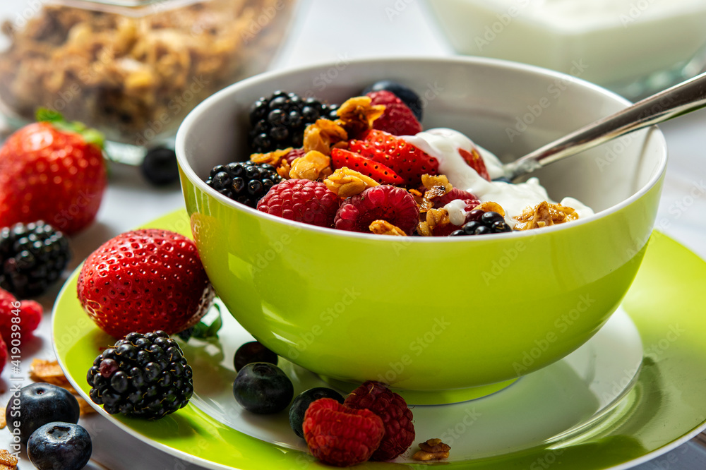 Close-up of a bowl of cereal enriched with soft fruits and yogurt. Close-up of a bowl of cereal enriched with soft fruits and yogurt.