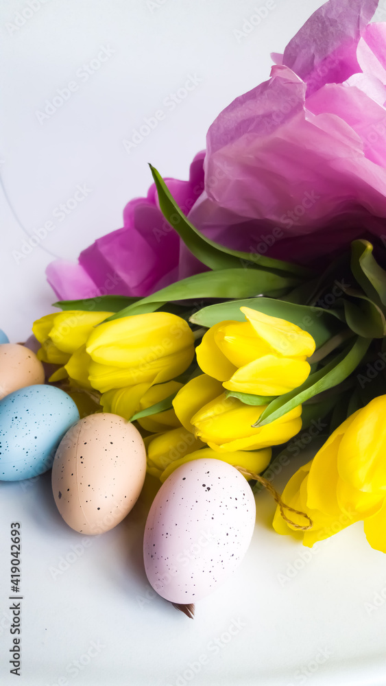 Spring composition of yellow tulips and Easter eggs. 