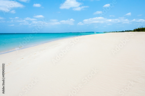 White sand beach with wind texture and a beautiful turquoise sea behind.