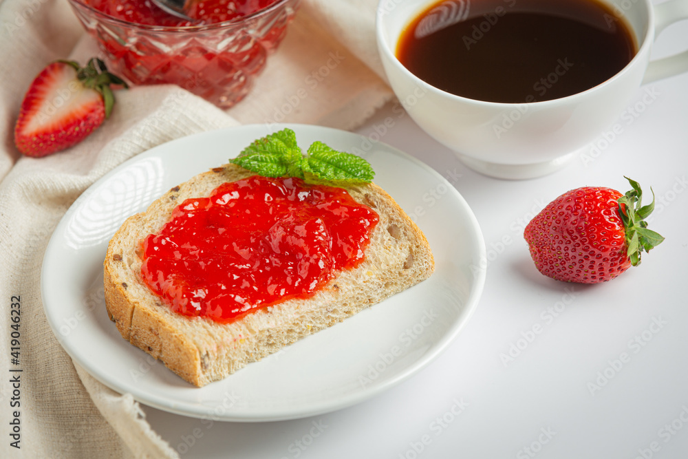Toasts with strawberry jam for breakfast on white background Toasts with strawberry jam for breakfast on white background