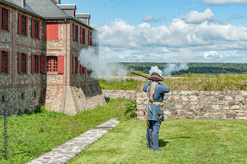 Fusilier discharging his muzzle loader on a National Historic site at the Fortress of Louisbourg