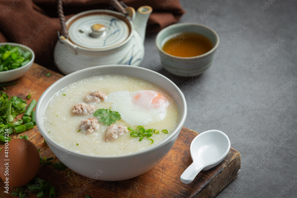 congee with minced pork in bowl on old dark background congee with minced pork in bowl on old dark background