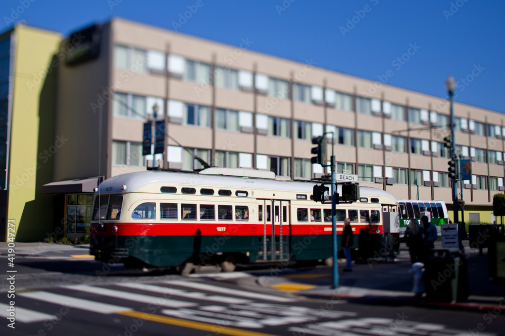 San Francisco Cable Trolley Car moves through the street California people-mover transportation. Tilt-shift lens photography effect.