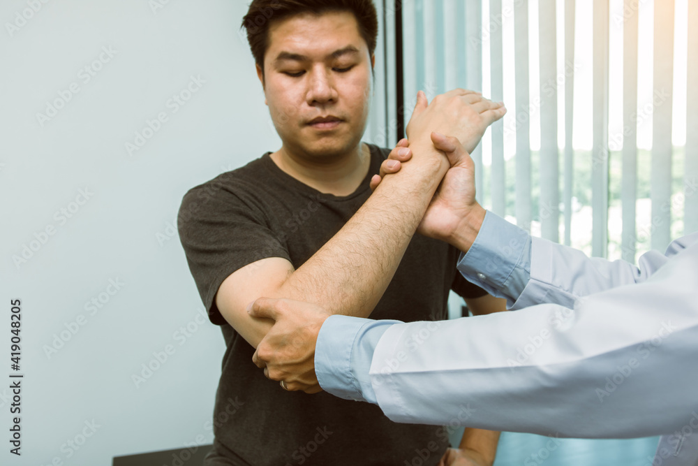 Asian physiotherapists check the elbows of patients who have undergone