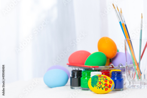 colorful Easter egg and bunny rabbit ears on table
