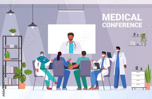 team of doctors having video conference mix race medical specialists discussing at round table medicine healthcare concept horizontal full length vector illustration