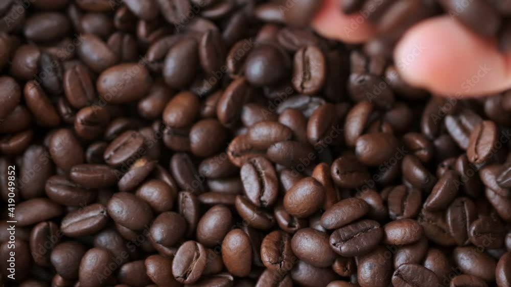 Human Hand touching Roasting brown Coffee Beans . tracking shot, close up Human Hand touching Roasting brown Coffee Beans . tracking shot, close up