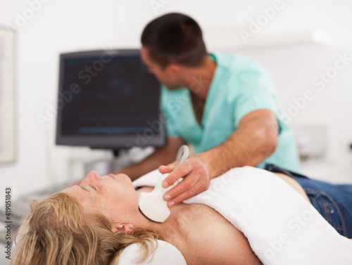 Portrait of female patient during ultrasound diagnostic in modern clinic