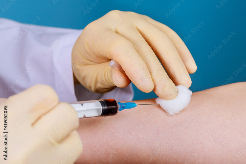 A nurse use a syringe to take a blood sample from a man to be tested for HIV AIDS A nurse use a syringe to take a blood sample from a man to be tested for HIV AIDS