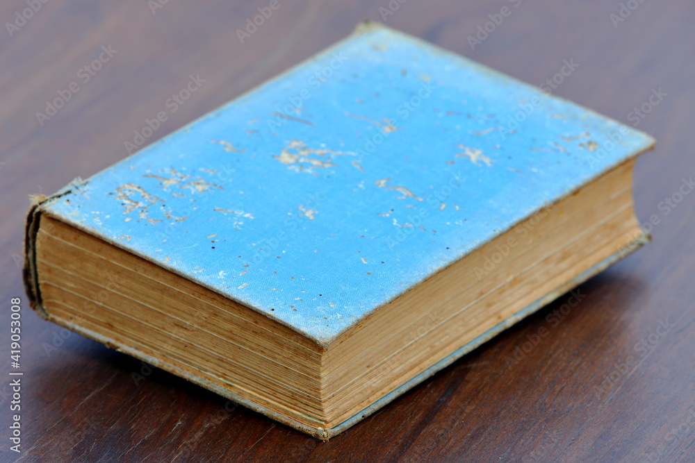 Fototapeta premium Really old book on wooden floor