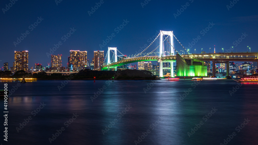 A long exposure image of a Rainbow bridge viewed from Odaiba island in Tokyo, Japan