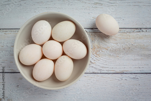 Duck eggs on white wooden background