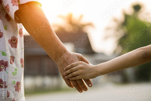 Close-up of hands joining together with sunlight 