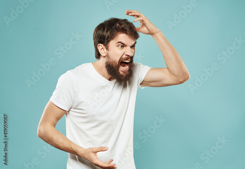 Angry guy gesturing with his hands on a blue background cropped with Copy Space