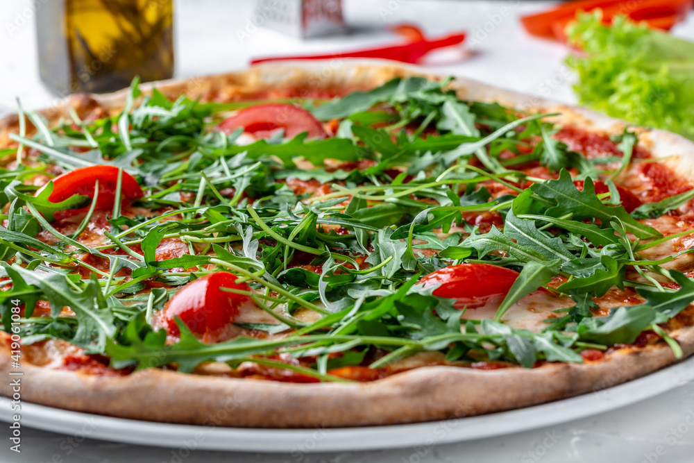 Pizza Margherita with Fresh Arugula Leaves, Tasty pizza with vegetables and arugula Pizza Margherita with Fresh Arugula Leaves, Tasty pizza with vegetables and arugula