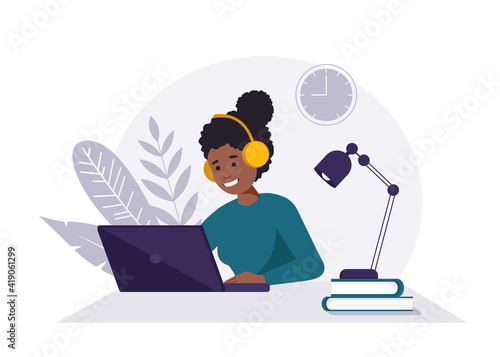 Home office concept, black woman with headphones and laptop working from home, student or freelancer