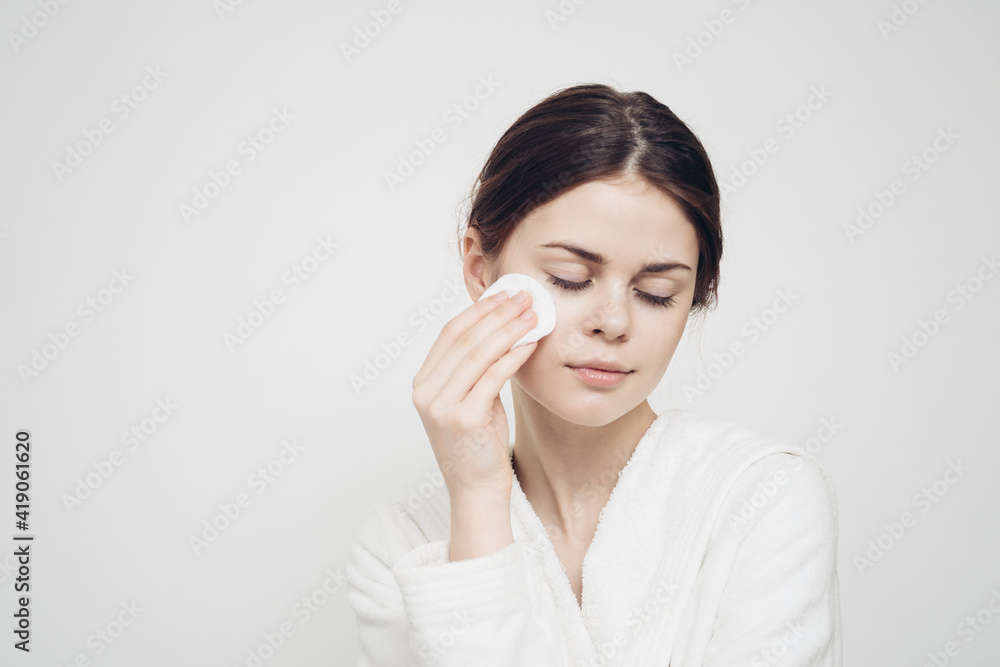 attractive woman with sponge and in white dressing gown attractive woman with sponge and in white dressing gown