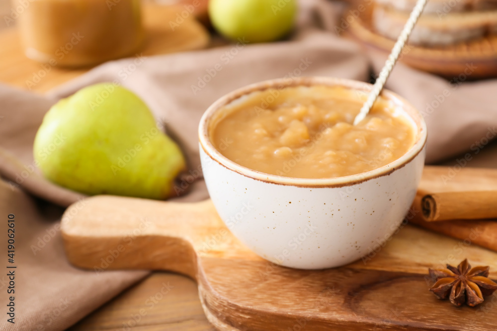 Bowl of tasty pear jam on wooden table Bowl of tasty pear jam on wooden table