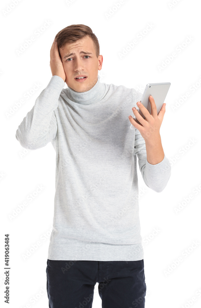 Stressed young man with tablet computer on white background. Concept of deadline
