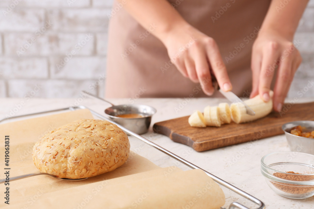 Woman cooking banana cookies in kitchen