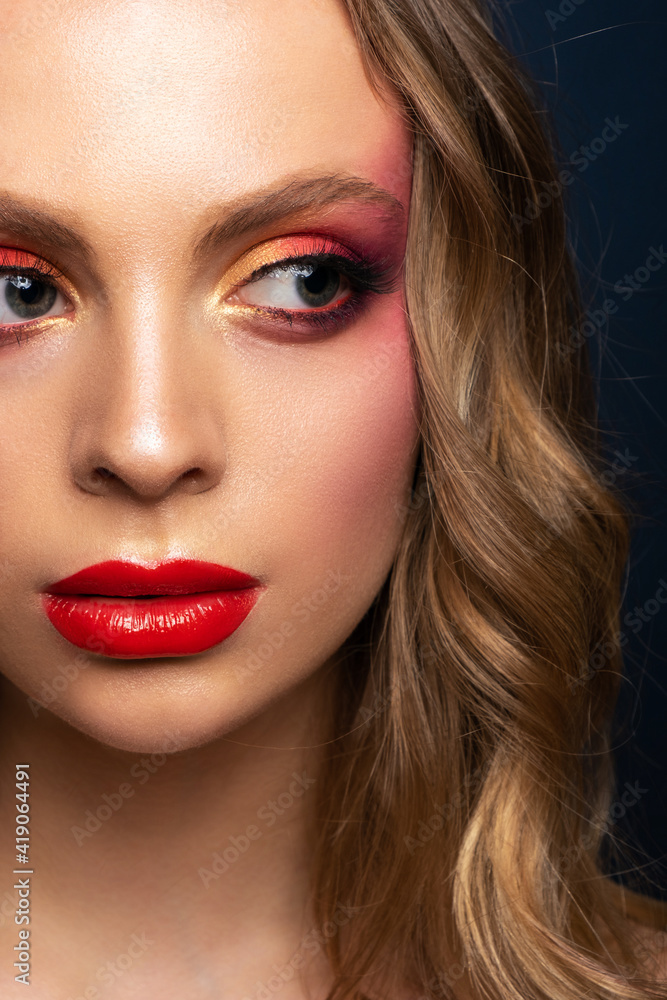 Close-up portrait of a beautiful model with a bright make-up and red lips. Close-up portrait of a beautiful model with a bright make-up and red lips.