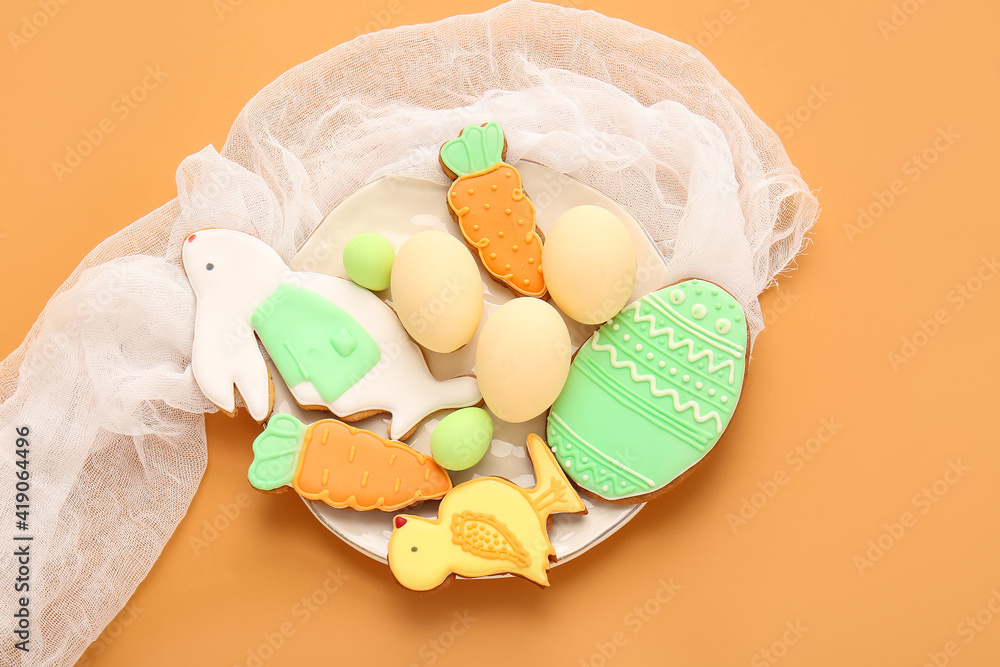 Plate with tasty Easter cookies and eggs on color background Plate with tasty Easter cookies and eggs on color background