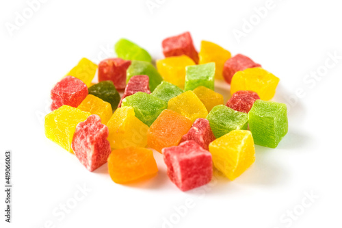 Multicolored cubes of sweet candied fruits isolated on white