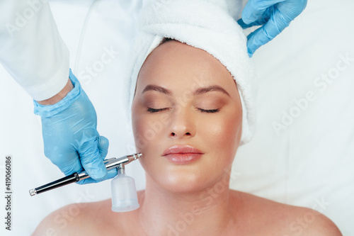 Beautiful woman getting facial skincare treatment in a cosmetic beauty clinic