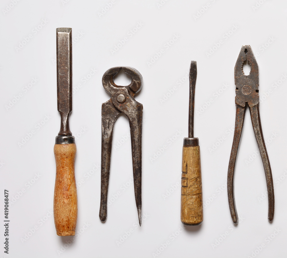 top view on white background old often used hand tools screwdriver and nippers, pliers and chisel. top view on white background old often used hand tools screwdriver and nippers, pliers and chisel.