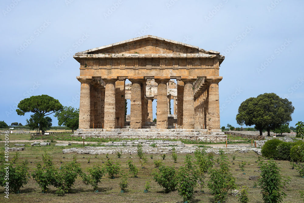 Paestum Archaeological Park with ruins of ancient greek city with temple, popular tourist landmark, guided tour concept, Italy