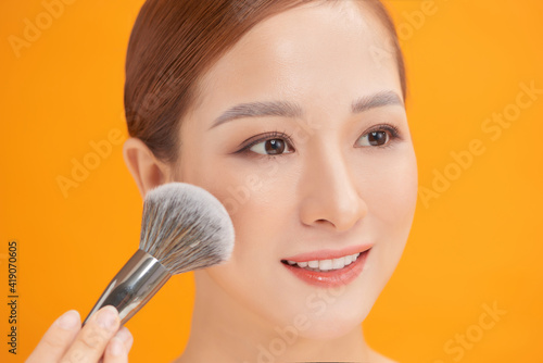 Woman making up makeup, foundation, brush