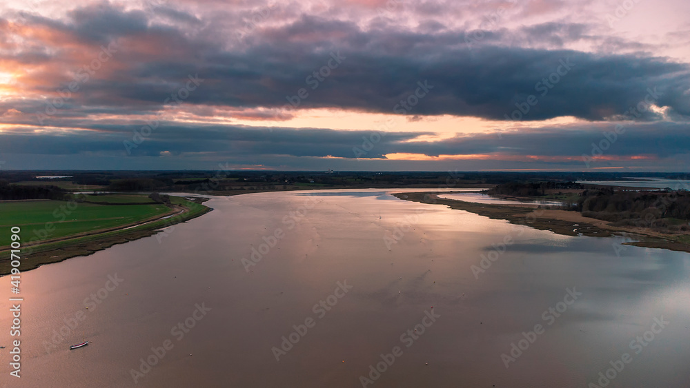 Obraz premium An aerial view at sunset over the River Deben at Ramsholt in Suffolk, UK