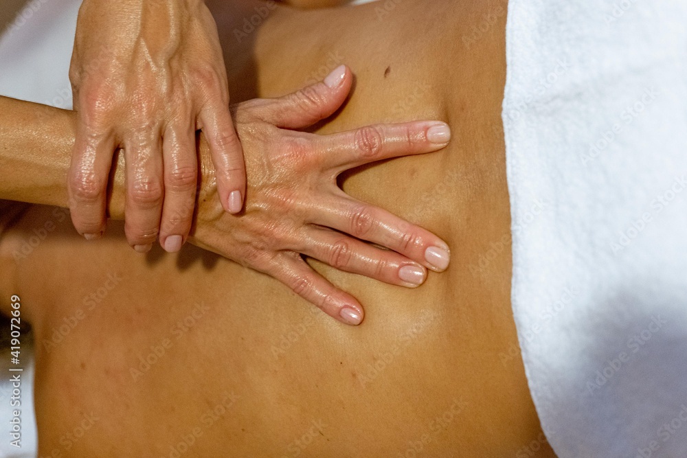 Chiromassage therapist giving a back massage to a client Chiromassage therapist giving a back massage to a client