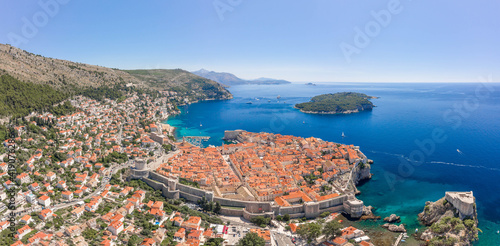 Aerial panorama drone shot of Otok Lokrum in Adriatic sea near Dubrovnik old town in Croatia summer noon