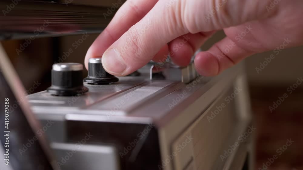Female Hand Adjusts Volume and Frequency to on Vintage Receiver with Antenna. 4K Female Hand Adjusts Volume and Frequency to on Vintage Receiver with Antenna. 4K